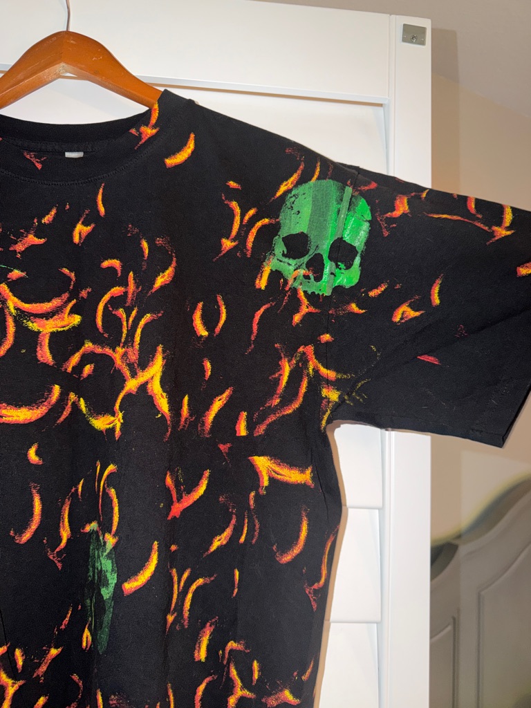 Black Graphic Tee With Neon Flame Print And Green Skulls